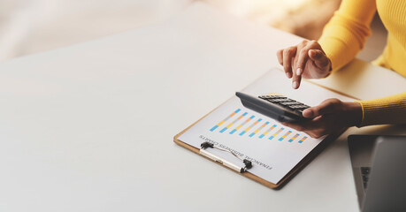 Accountant working on desk using calculator to calculate financial report in office business accounting finance concept