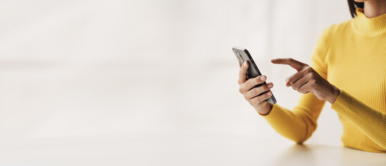 Portrait of a young woman holding a mobile phone to use social media on a smartphone. Communicate via the Internet on a smartphone. concept of using technology in communication