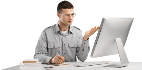 Young Caucasian man worker speak in glasses look at computer operational problems. Frustrated man surprised by unexpected error on computer device.