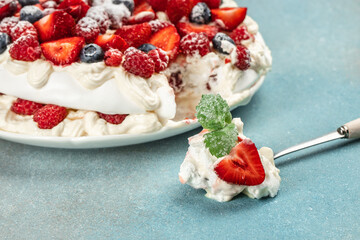 pavlova cake with fresh raspberries, blueberries and strawberries, Food recipe background. Close up