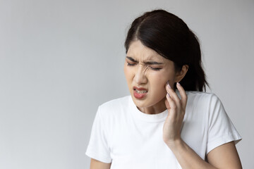 Asian Woman with Toothache: Seeking Dental Pain Relief and Oral Health Care