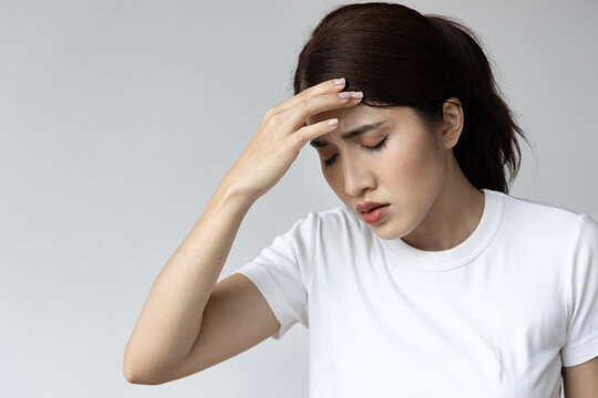 Stressed Asian Woman with Headache, Managing Stress and Finding Relief for Headache Pain