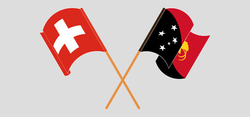 Crossed and waving flags of Switzerland and Papua New Guinea