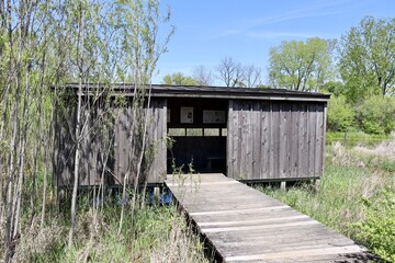 The old wood bird blind in the park on a sunny day.