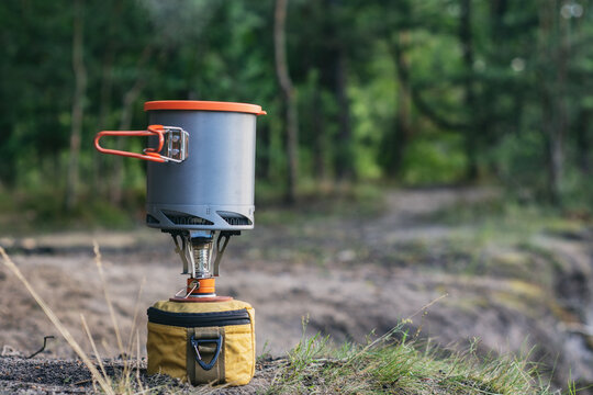 Tourist stove gas for camping and recreation on the background of nature.