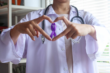 Close up doctor showing heart shape with  purple ribbon. Epilepsy awareness and World Cancer Day...
