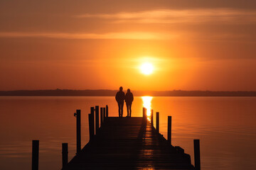 couple in love on the bridge admiring the sunset sun in sea generative ai