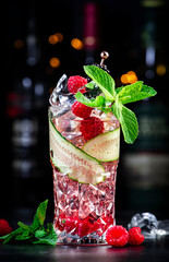 Rose garden alcoholic cocktail drink with dry gin, tonic, rose syrup, lychee juice, lemon,...