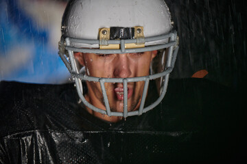 American Football Field: Lonely Athlete Warrior Standing on a Field Holds his Helmet and Ready to...