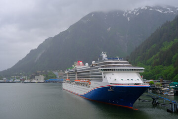 Modern cruiseship cruise ship liner Spirit docked at terminal in Juneau, Alaska during heavy rain...