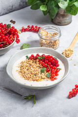 Oatmeal. Granola with yogurt and red currant
