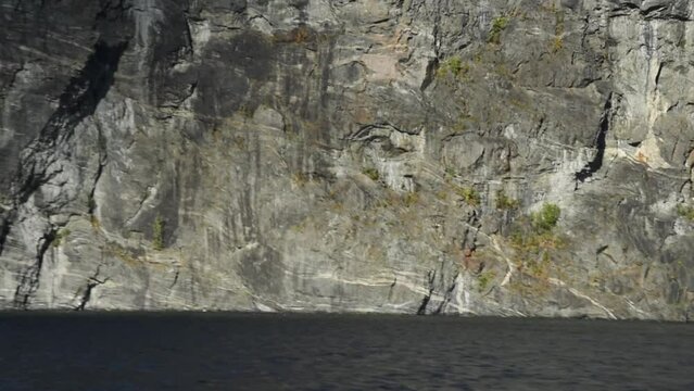 View along the grey granite walls of Sognefjord,  Aurlandsfjord Flam, Norway. Impressive mountain landscape of fjords 