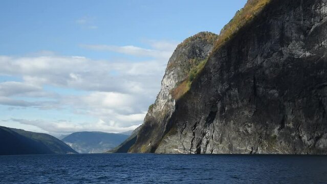 View from an electrical cruise ship on Sognefjord in Norway. Impressive mountain landscape of fjords and blue water