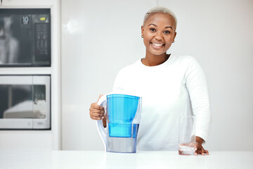 Water, filter and pitcher for woman in kitchen to refresh with glass of liquid hydration. Portrait,...
