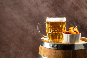 Beer glass and dried fish snack on wooden barrel. banner, menu, recipe place for text