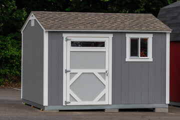 cute small wooden storage shed, with windows and shingle roof nice entrance door design