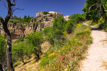 Footpath to the rock wall at the bridge Puente Nuevo in the Andalusian city of Ronda, Spain