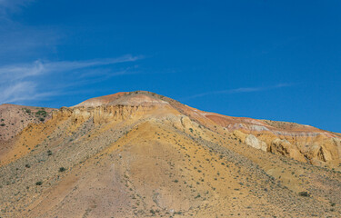 multi-colored sandstone mountain against the blue sky