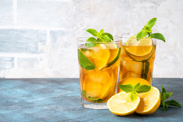 Iced tea with lemon, lime, mint and ice.