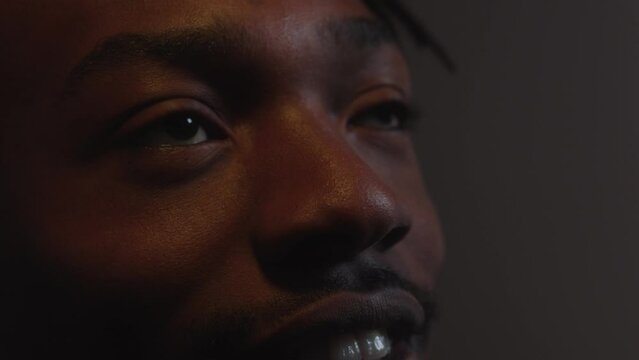 Man reacting shocked an scared by something on the cinema screen in close up