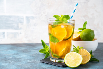 Iced tea with lemon, lime, mint and ice.