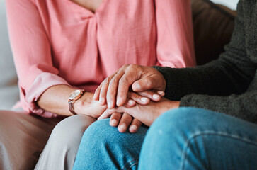 Closeup, couple and holding hands to forgive, love and care with empathy at home. Life partner,...