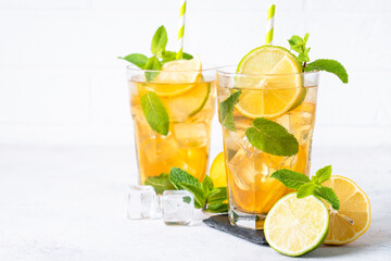 Iced tea with lemon, lime, mint and ice.