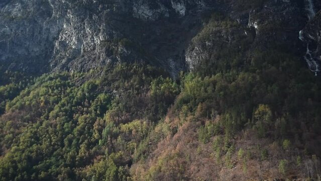 close up view over a forestry mountain landscape in sognefjord of norway.  Steep granite walls, autumn forest and waterfalls