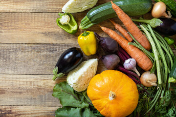 Fresh vegetables on a wooden background. Harvest. Vegetarian. Healthy diet concept. View from above. Copy space.