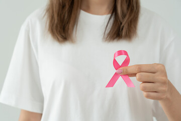 Woman hold pink ribbon breast cancer awareness. Female health check consciousness. international...