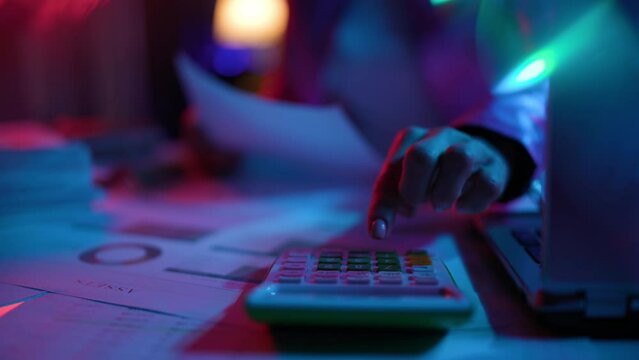 Closeup on modern female with calculator and documents in modern office.