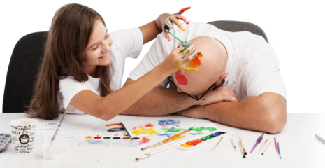 Painting concept. Schoolgirl painting with father during therapy at home with his tutor with learning and having fun together.
