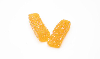 Two orange chewy gummy sticks sprinkled with sugar isolated on white background