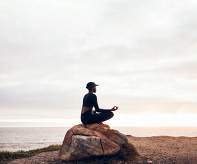 Lotus pose, woman and yoga at the beach, fitness and meditation with spiritual wellness in nature....