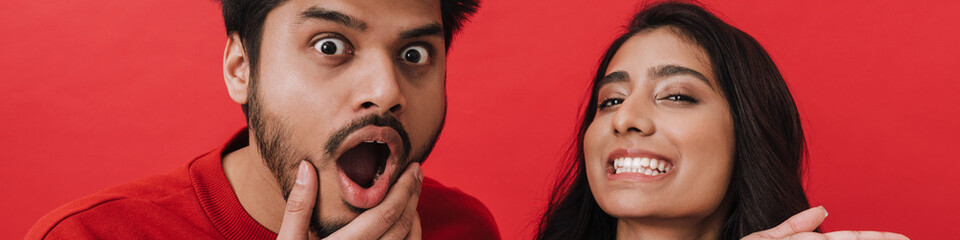 Young indian couple expressing surprise while posing together