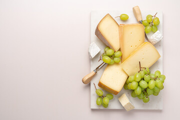 Variation of farmer's cheese on marble board. Cheese platter on light background top view