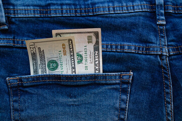 dollars bills lies in jeans pocket.money in wallet.savings.cash.international currency.
currency...
