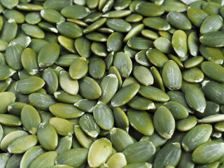 Pumpkin seeds close-up in full screen. Peeled pumpkin seeds without peel. Top view.