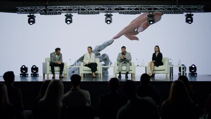 Group of 4 experts having a conversation on stage during AI artificial intelligence conference. Future technology meetup. Talks about Neural Networks, Big Data and Machine Learning. Live Event 
