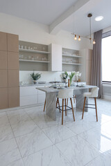 close view kitchen with dinning marble table and hight bar stools in minimalistic light elegant luxury design of a modern spacious studio apartment in soft pastel beige colors