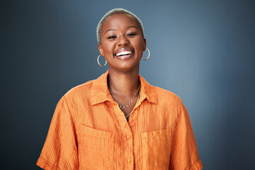 Smile, laugh and portrait of black woman laughing in studio at silly, joke or funny against a...