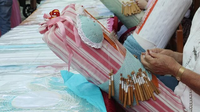 Woman making bobbin lace by hand