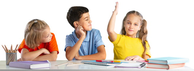 Concept of education. Elementary school child, ready to answer the teacher's questions in class. Smart little is sitting at a desk next to her classmate in the classroom.