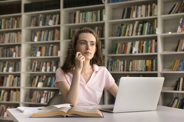 Thoughtful dreamy pretty student girl thinking on research study, class project, homework creative...