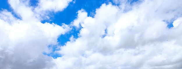 Blue sky background with white clouds. Beauty bright air background. Gloomy vivid cyan landscape.