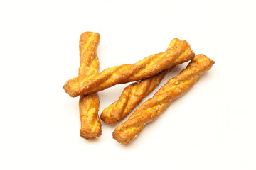 Few salty and  twisted pretzel sticks isolated on white background. Italian snack - obrazy, fototapety, plakaty