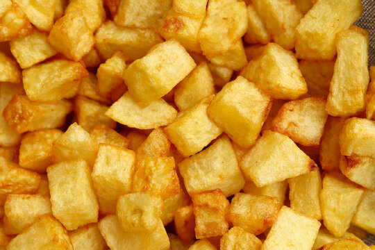 Dice sliced fried potatoes close up