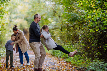 Fototapeta premium Happy family having fun with kids in a forest.