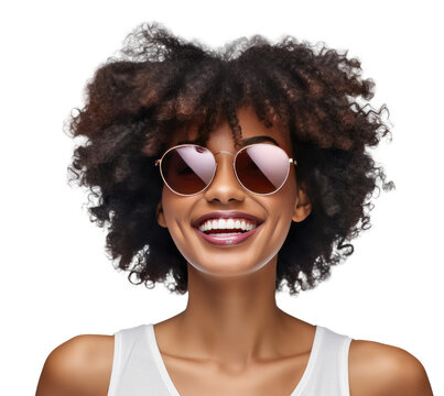 A woman with an afro hairstyle smiling and wearing sunglasses