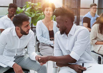 Obraz premium Positive multiracial diverse business people in formal and casual wear are discussing forum